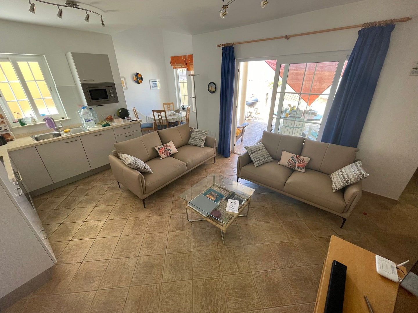 Open-plan living room with kitchen and dining areas